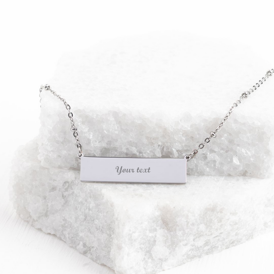 Engravable silver bar necklace with sample "Your text" engraving on white stone