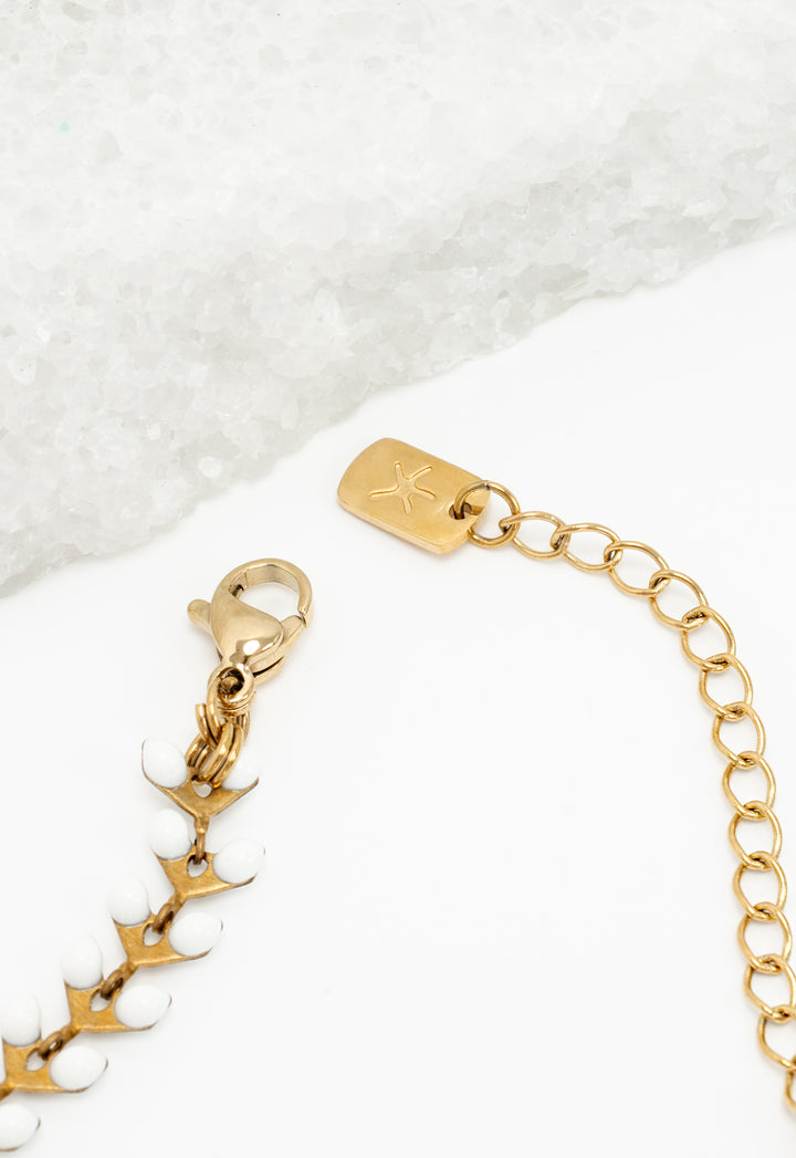 Close-up of lobster clasp and Starfish Project logo tag on gold extender chain