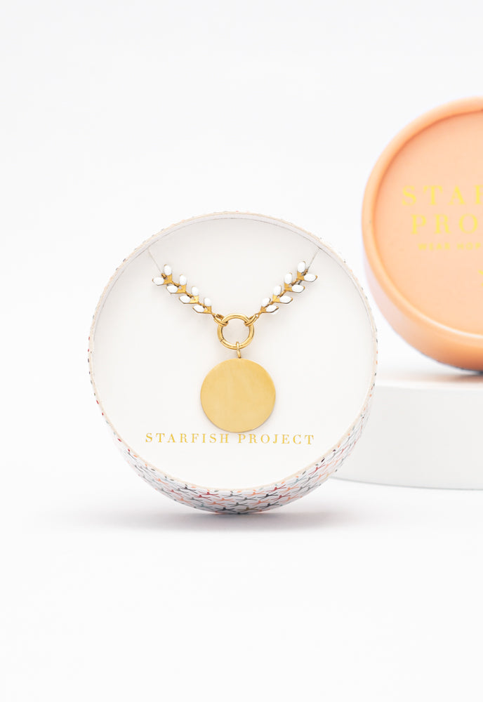 Engravable round pendant on ivory Seeds of Hope chain in a Starfish Project gift box
